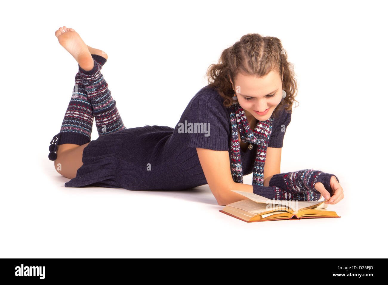 Smiling young woman reading a book over white background Stock Photo ...