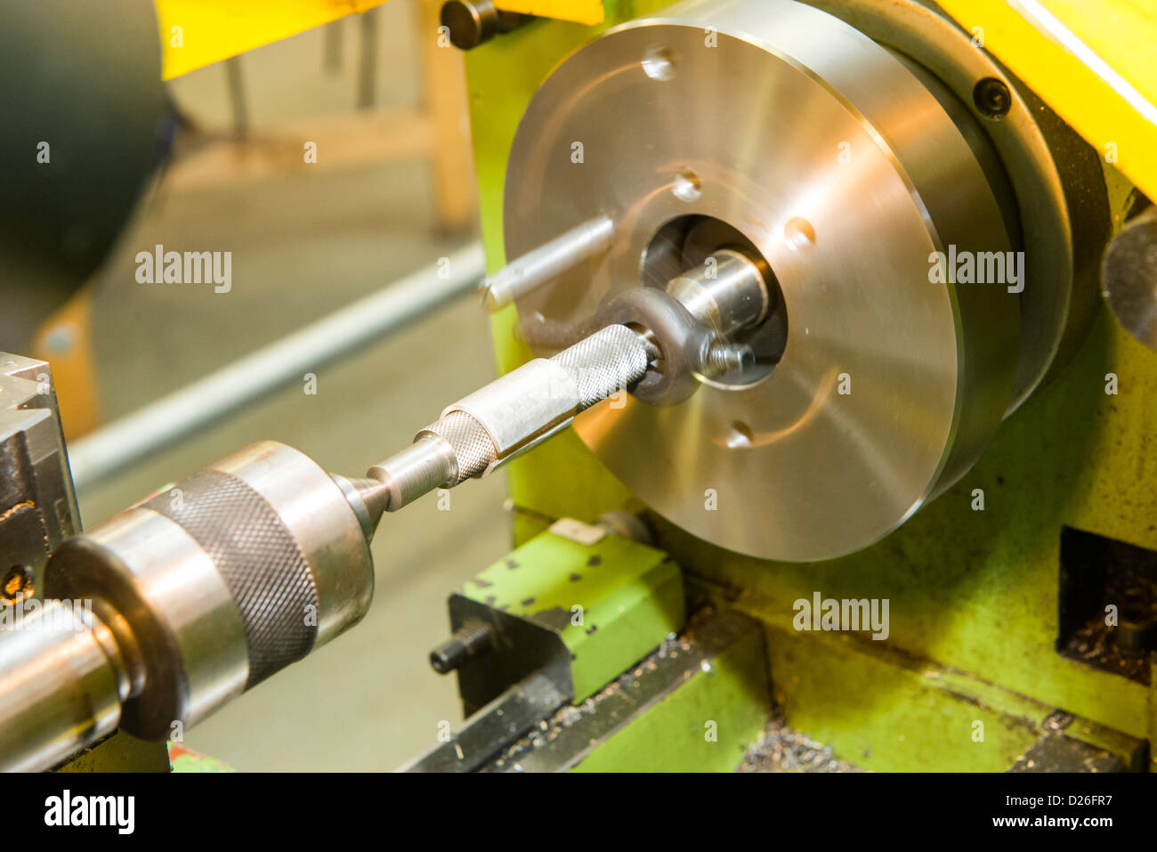 A go-no-go gauge being turned on an industrial metal turning lathe between centres using a face plate and drive dog. Stock Photo