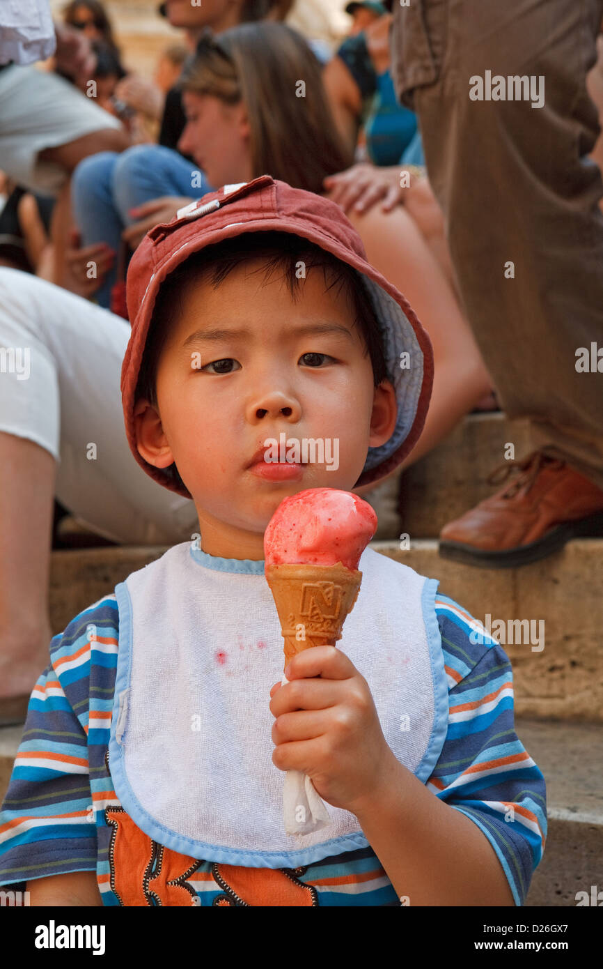 A young child eating an ice cream on a hot summers day on the Spanish