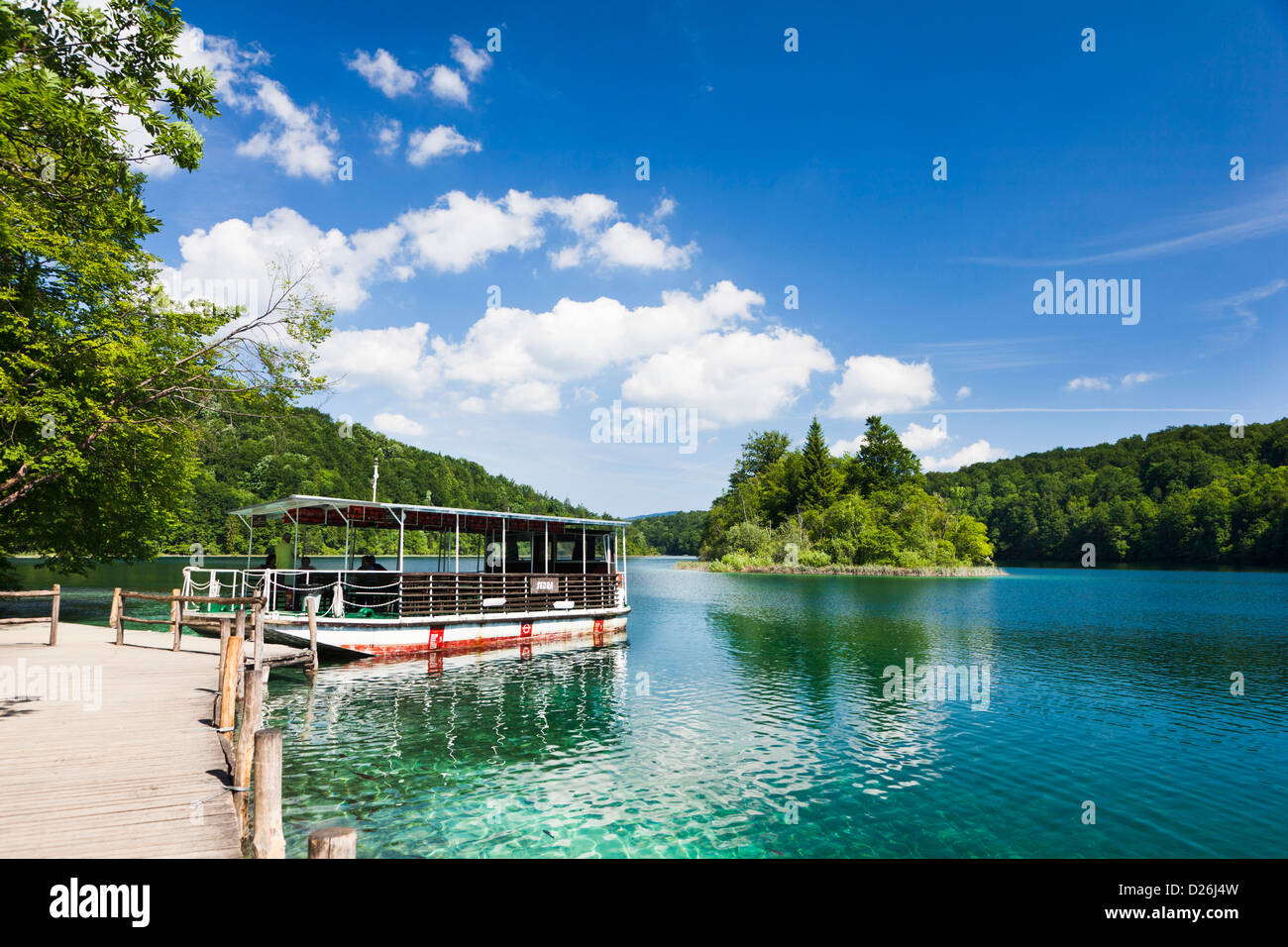The Plitvice Lakes in the National Park Plitvicka Jezera in Croatia. Visitors taking a cruise on lake Kozjak. Stock Photo