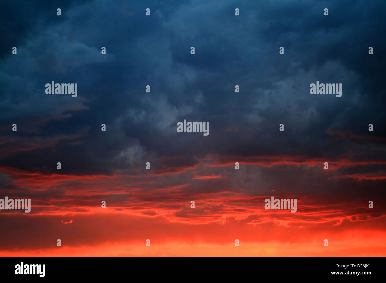 Ominous clouds above fiery sunset Stock Photo