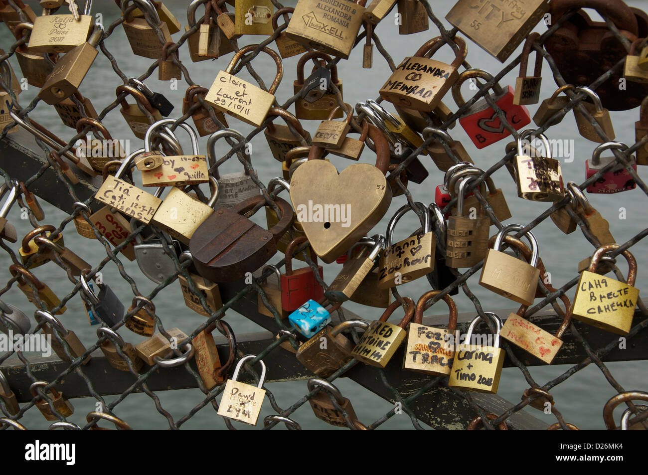 “Padlocks of love” attached to the Passerelle Pont des Arts, which bridges the River Seine in Paris. Sweethearts throw the key into the water. France Stock Photo