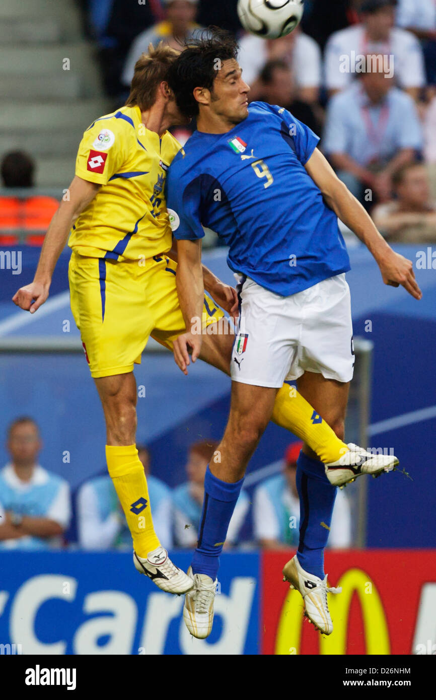 Viachevslav Sviderskyi of Ukraine (L) and Luca Toni of Italy (R) vie for a header during a FIFA World Cup quarterfinal match. Stock Photo