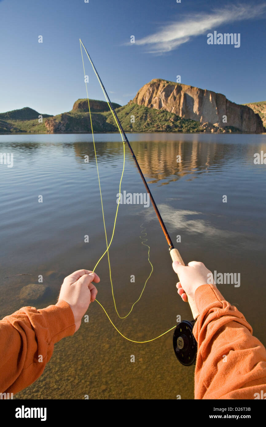 Hands of a fly fisherman using a fly road at Canyon Lake in Arizona Stock Photo