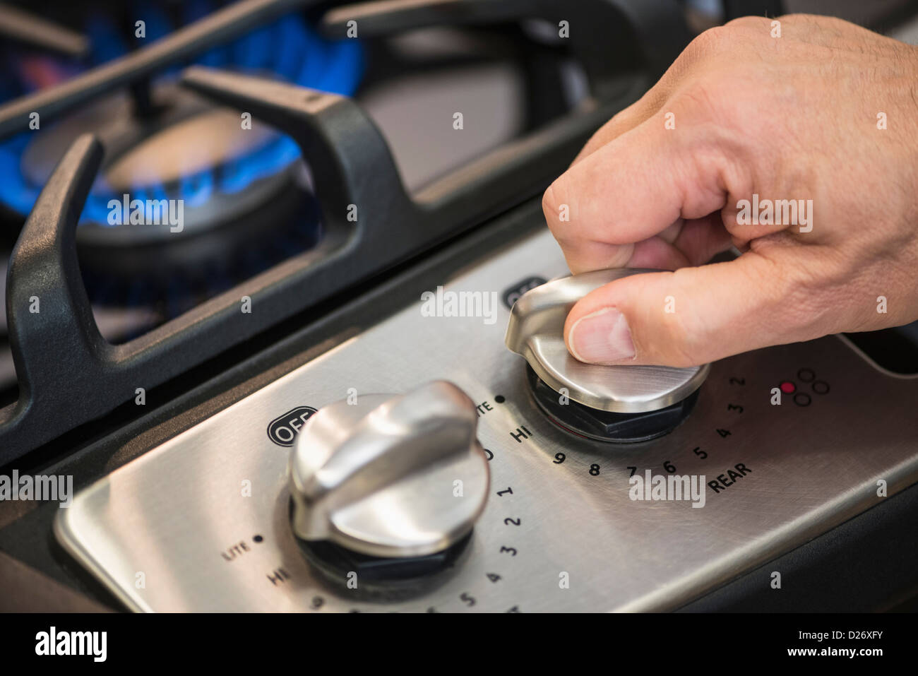 USA, New Jersey, Jersey City, Closeup of hand adjusting stove burner