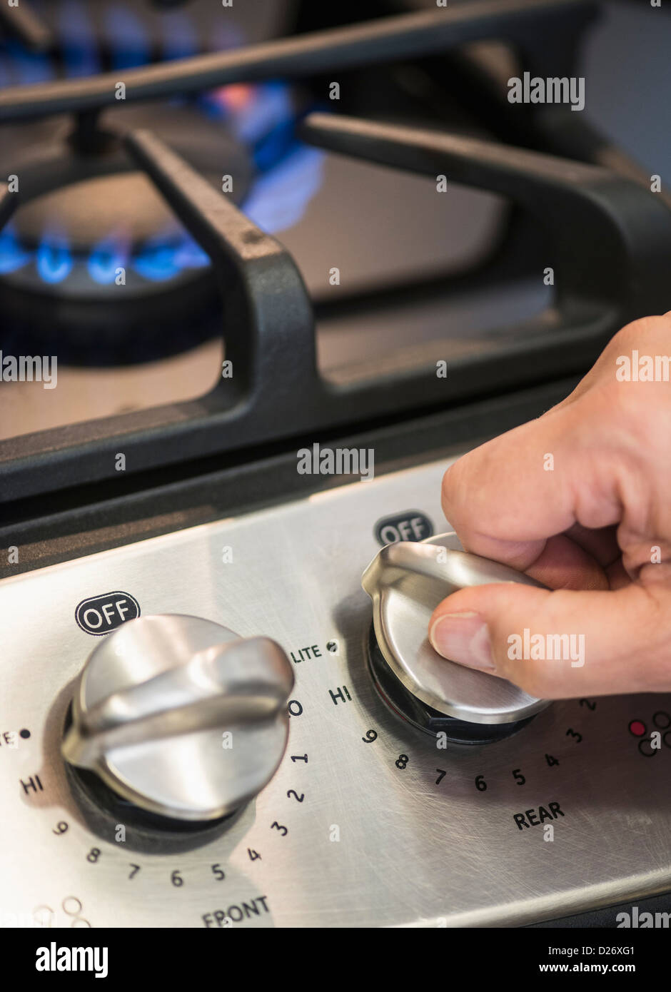 USA, New Jersey, Jersey City, Close-up of hand adjusting stove burner Stock Photo