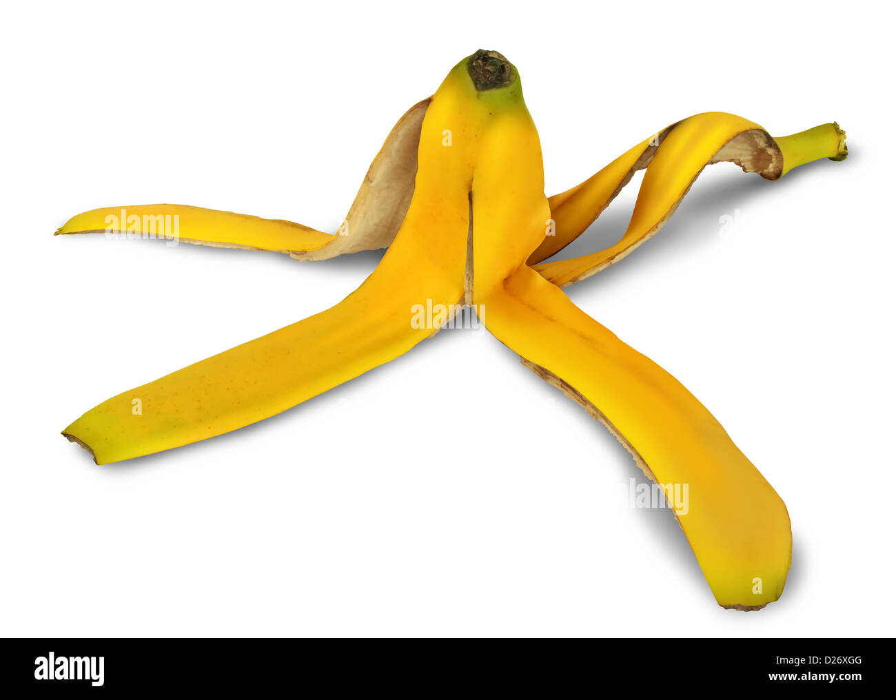 Banana peel on a white background with a shadow as a symbol of danger and risk of slipping on the yellow tropical fruit and an icon of natural garbage discarded for composting and recycling. Stock Photo