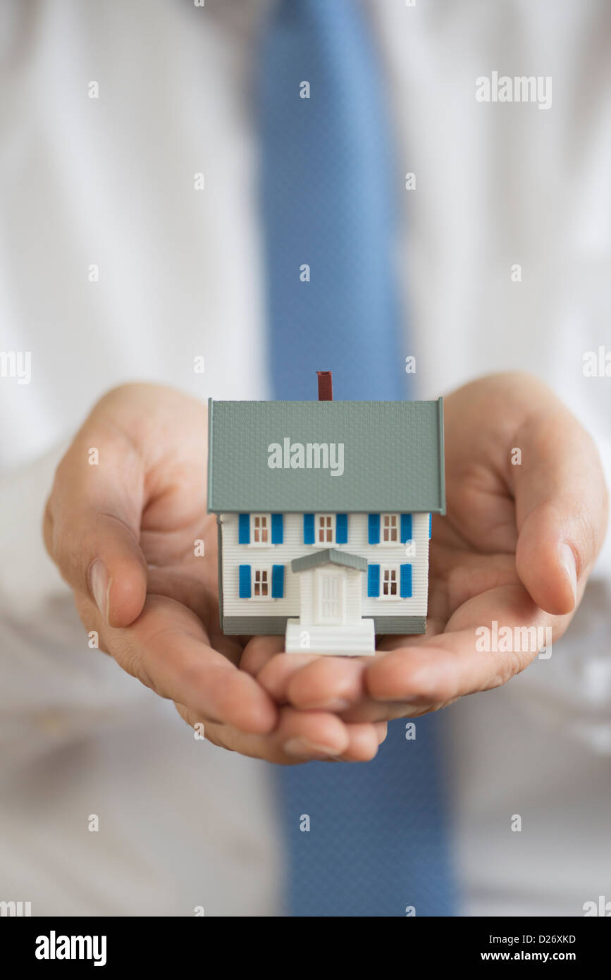 Man holding model house Stock Photo - Alamy