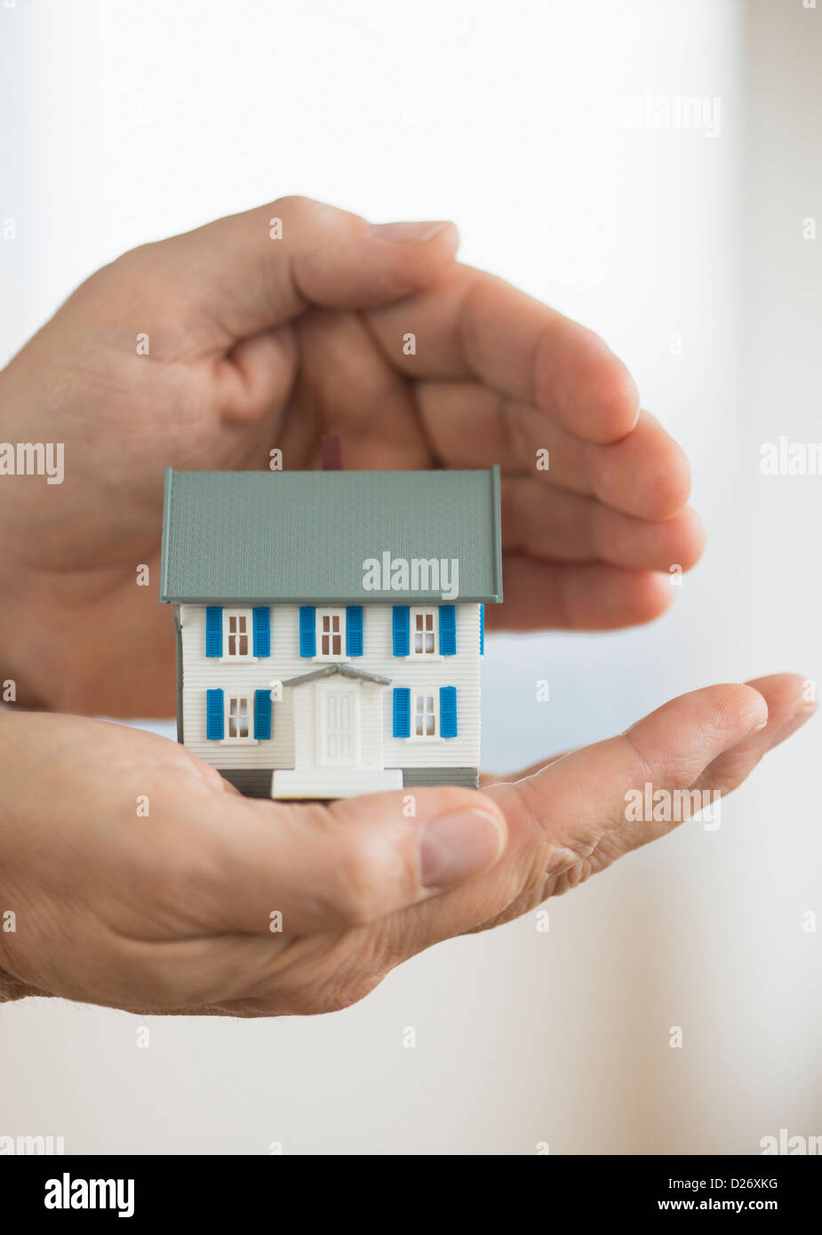 Hands holding model house Stock Photo - Alamy