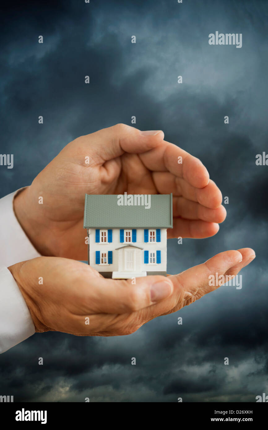 Hand holding house model hi-res stock photography and images - Alamy