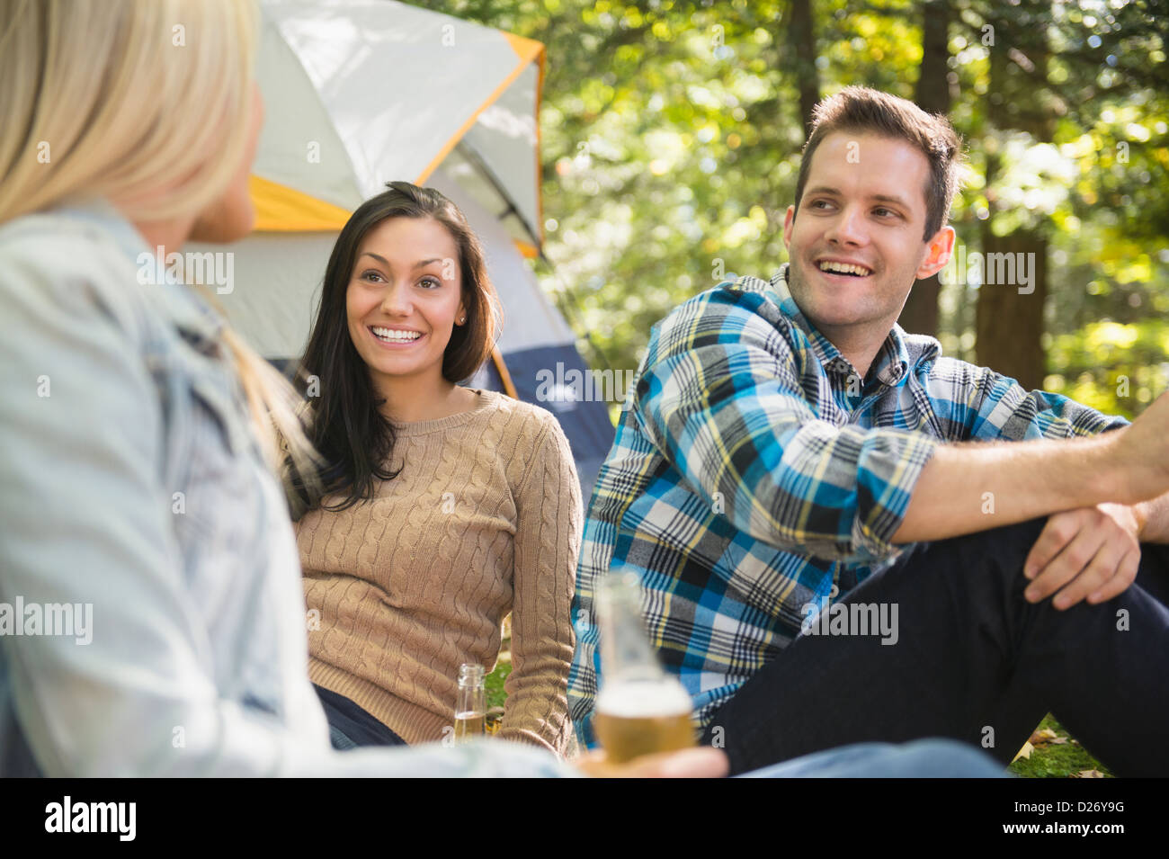 USA, Connecticut, Newtown, Three friends camping in forest Stock Photo