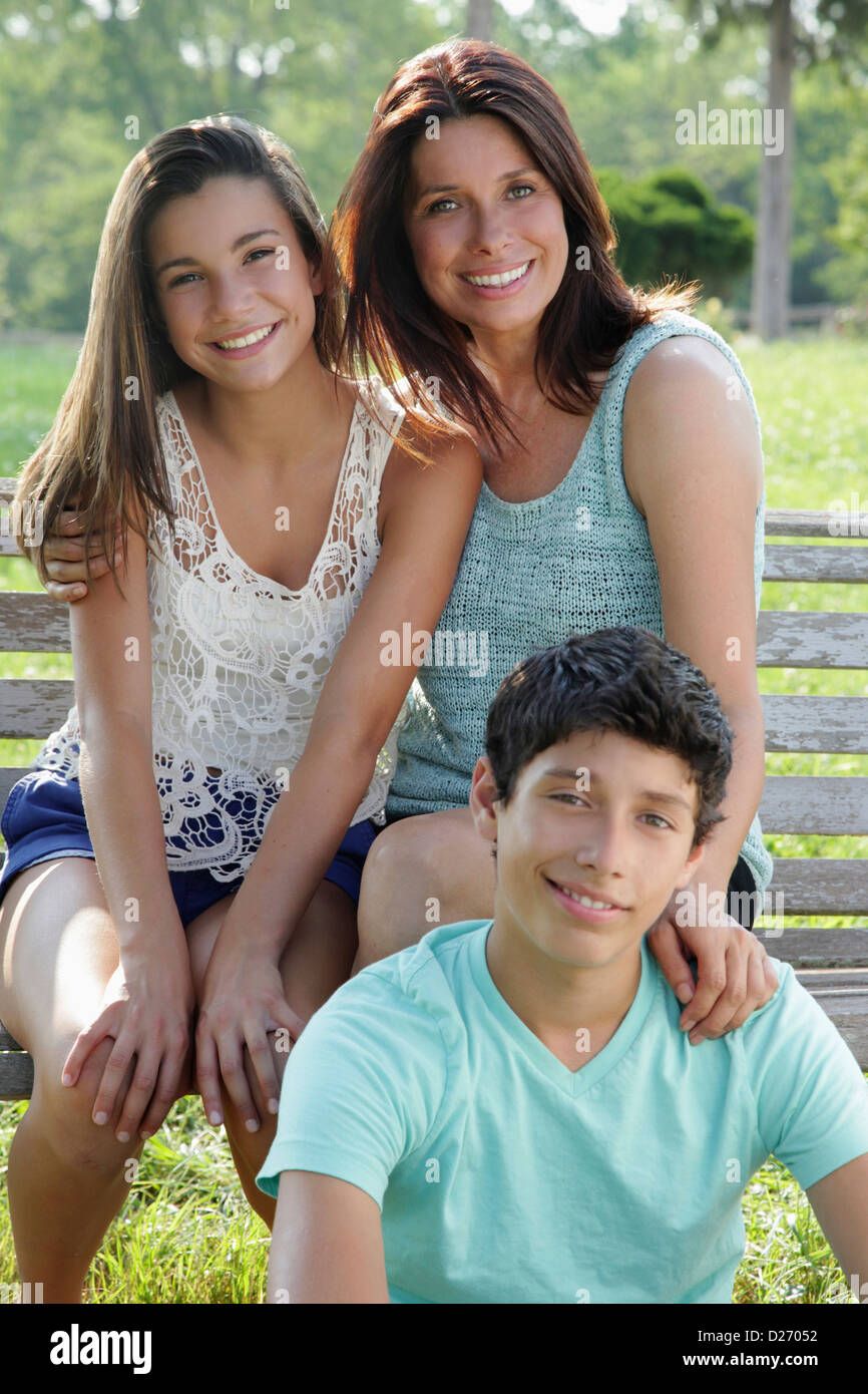 USA, New Jersey, Old Wick, Outdoor portrait of smiling mother with daughter (12-13) and son (14-15) Stock Photo