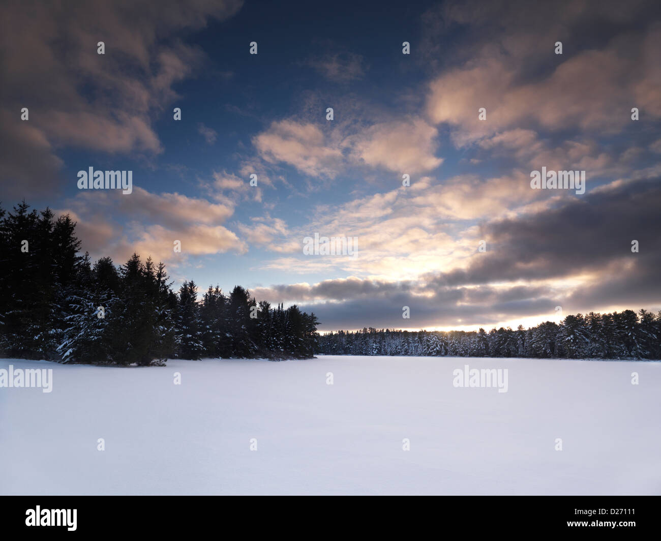 Covered with snow frozen lake sunset winter landscape nature scenery at Algonquin Provincial Park, Ontario, Canada Stock Photo