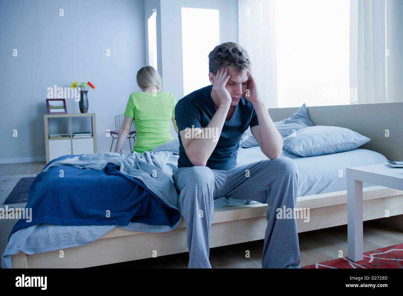 Angry couple sitting on bed Stock Photo