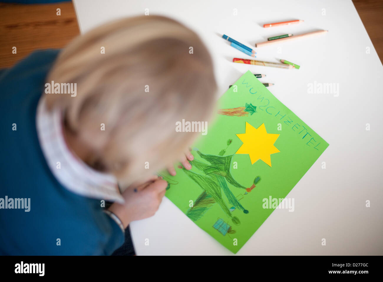 A little girl is drawing a wish list for Christmas. Stock Photo
