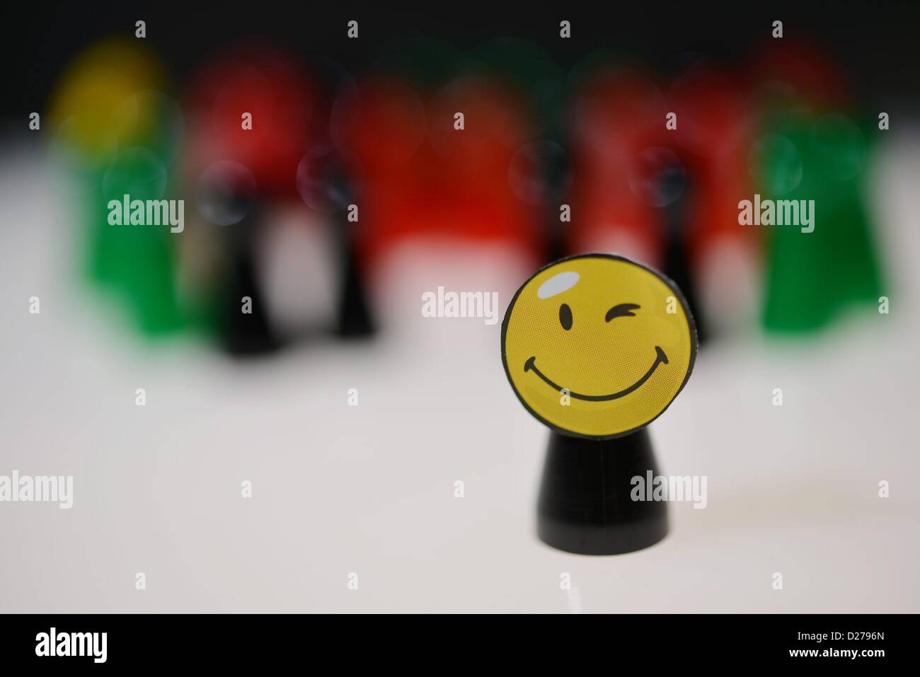 Pawns of a game standing on a table. Photo: Frank May Stock Photo