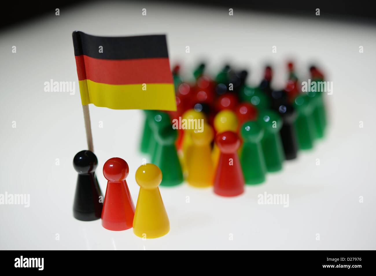 Pawns of a game standing on a table. Photo: Frank May Stock Photo