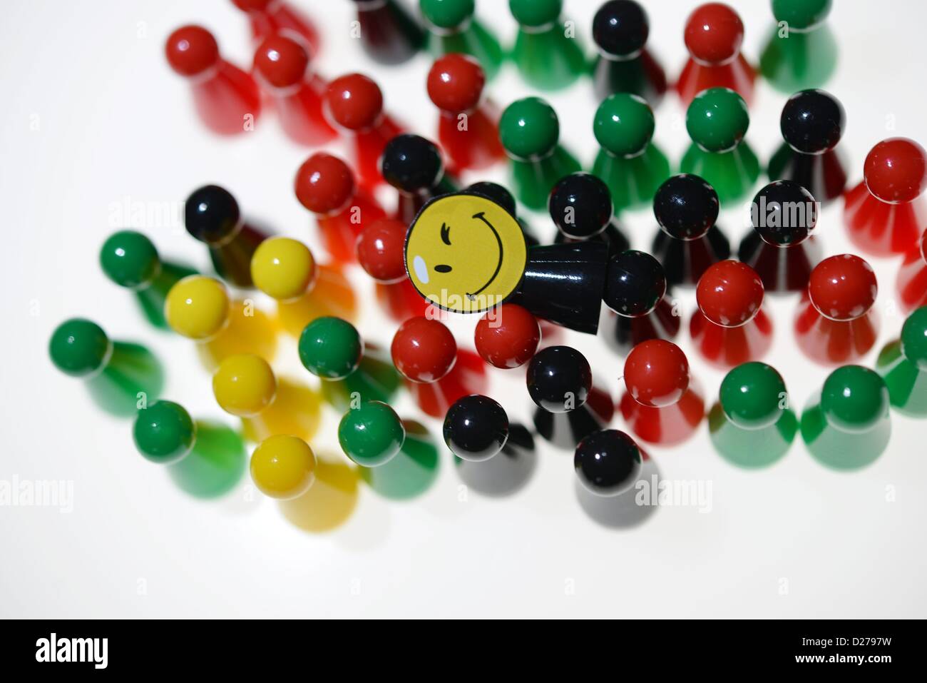 Pawns of a game standing on a table. Photo: Frank May Stock Photo