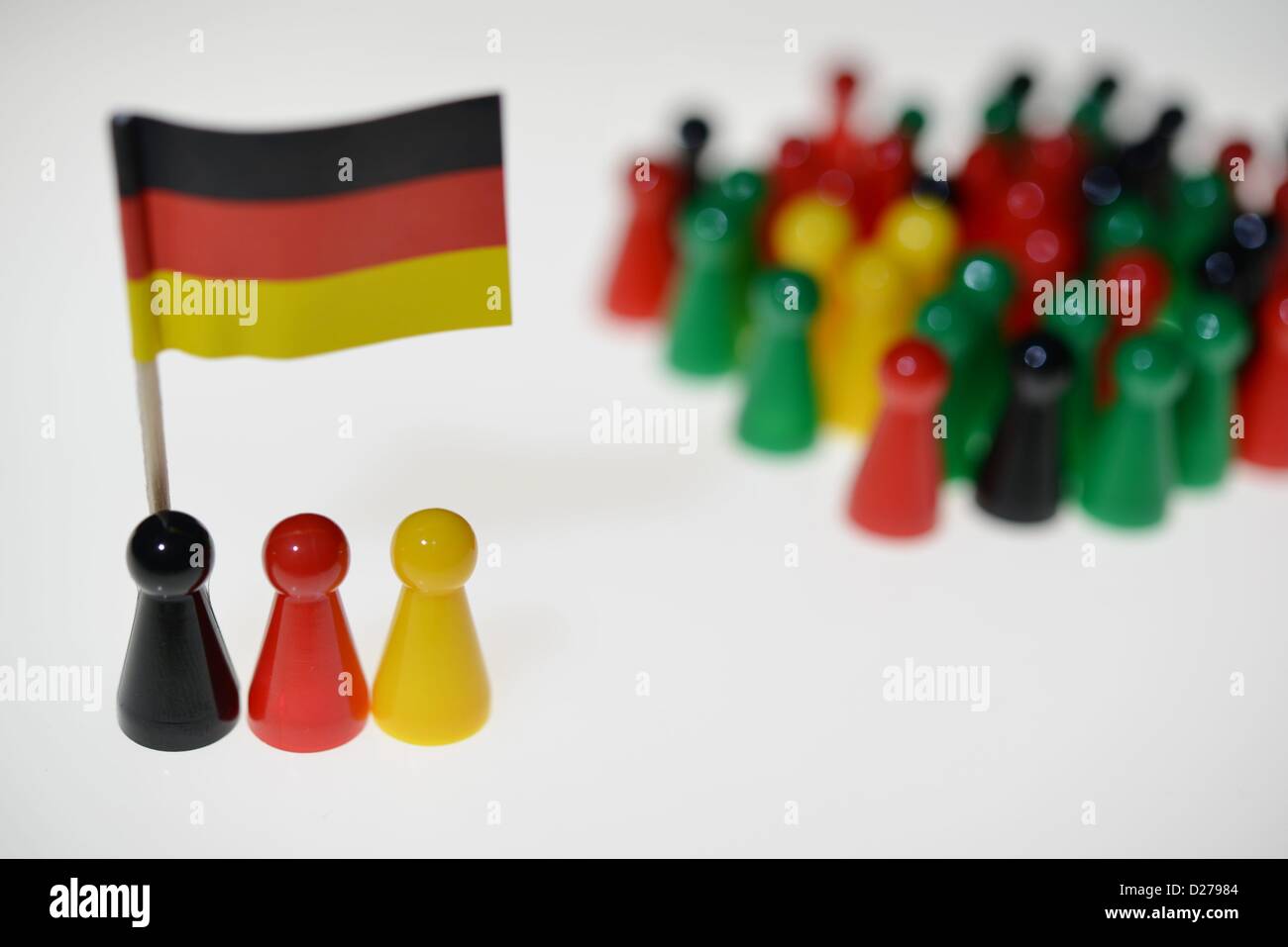 Pawns of a game standing on a table. Photo: Frank May Stock Photo