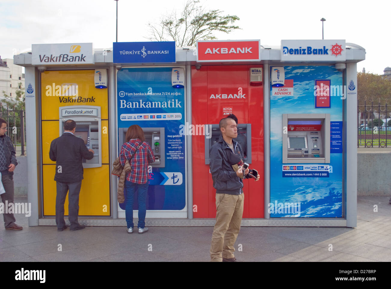Customers at bank of ATM cashpoints beside Galata Bridge in Istanbul, Turkey. Stock Photo