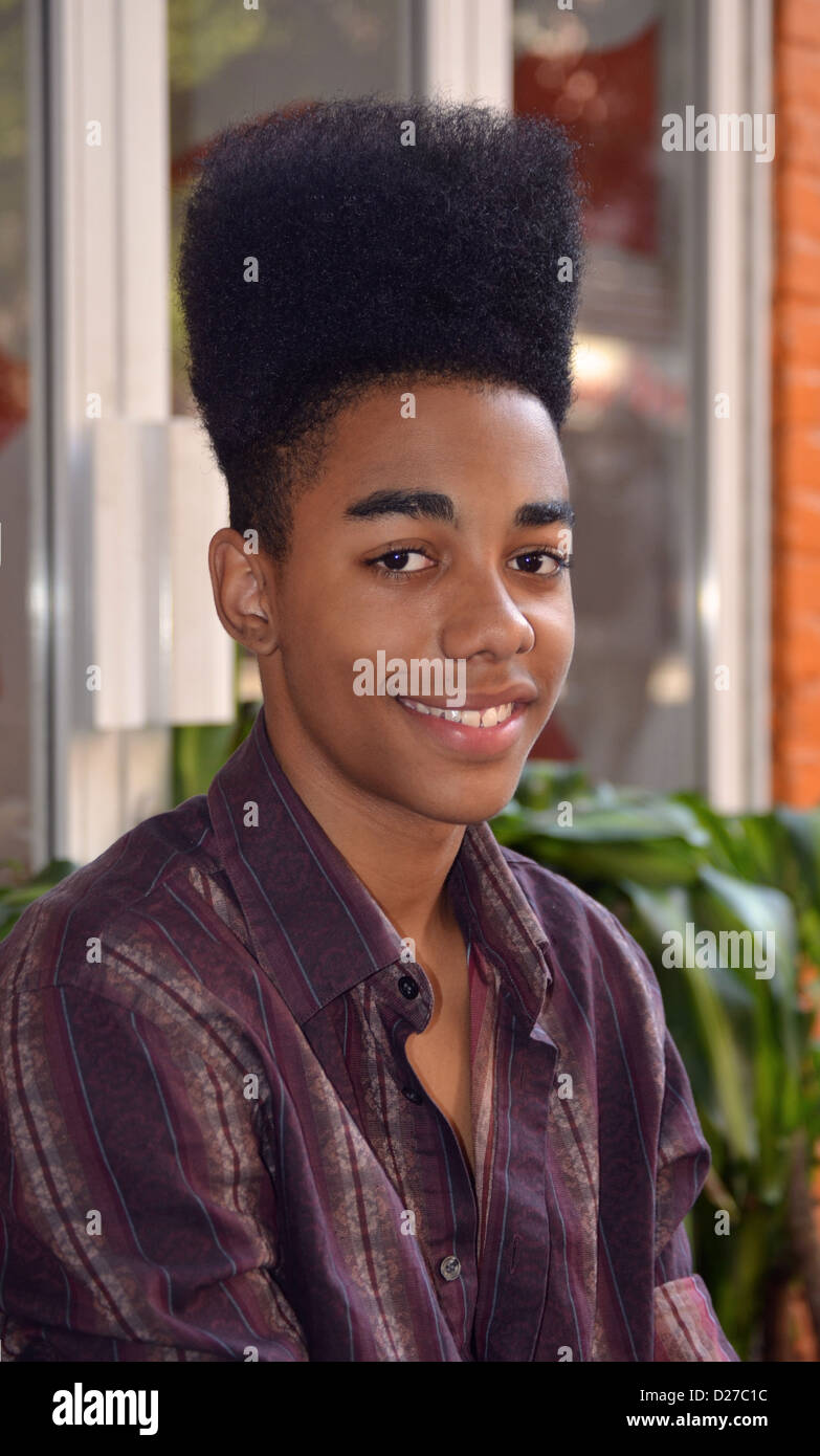 Portrait of a young man a high top fade hairdo photographed in the East Village section of New York City. Stock Photo