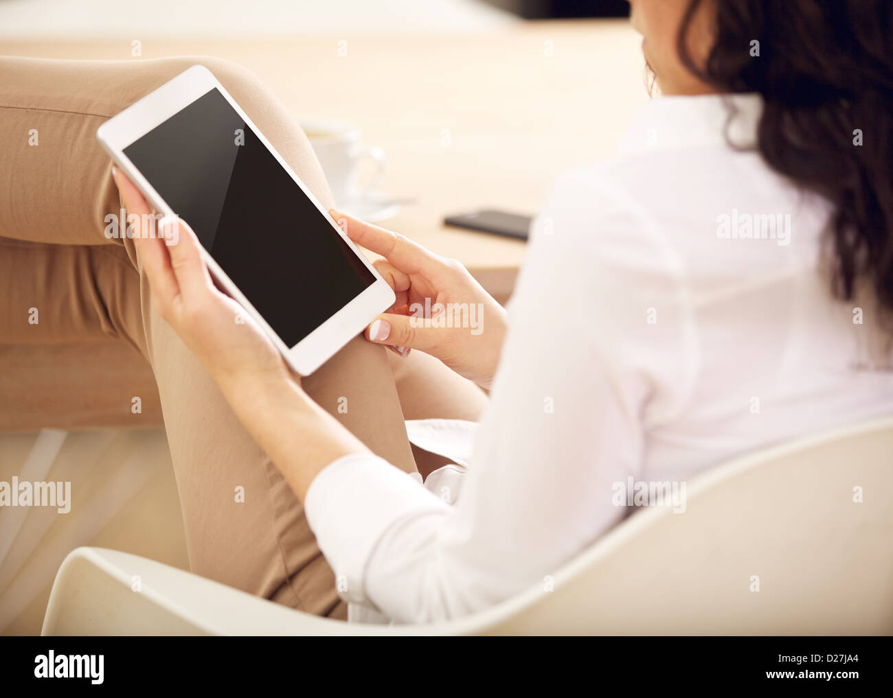 Young businesswoman holding an android digital tablet with empty screen Stock Photo