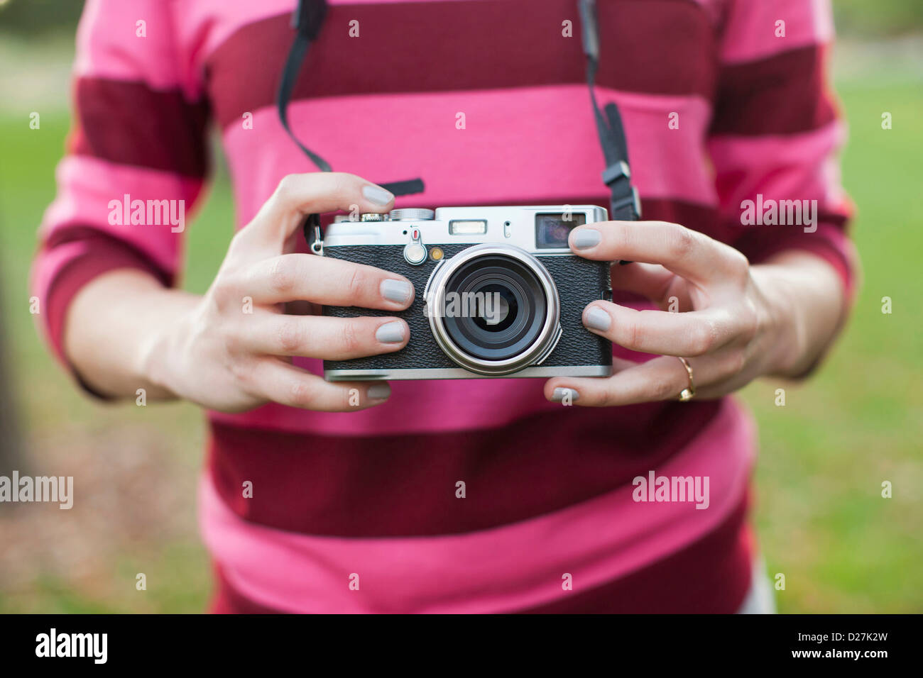 USA, Utah, Salt Lake City, Midsection of woman holding old camera Stock Photo