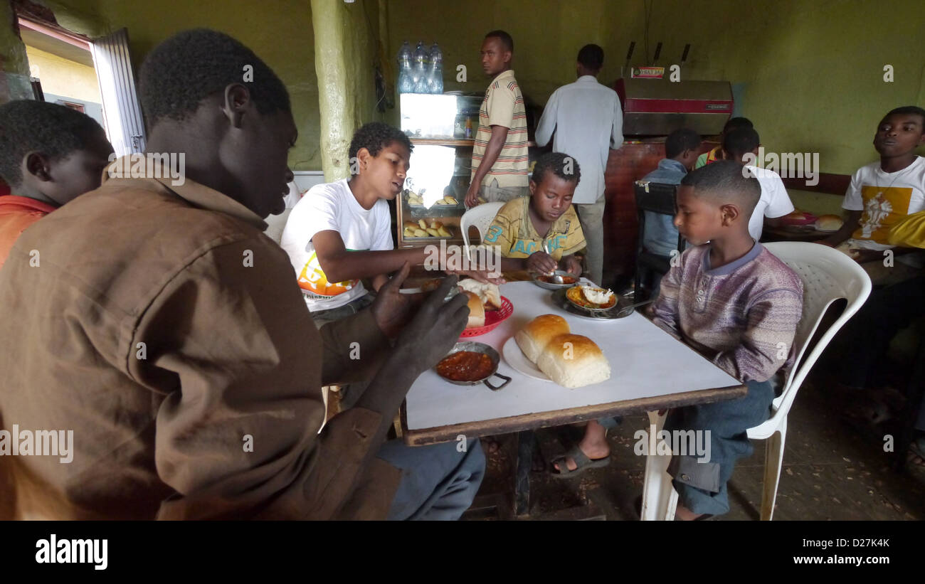 ETHIOPIA The 'Salam Cafe' in Chagni, Beni Shangul Gumuz region. Boys having breakfast of beans. Stock Photo