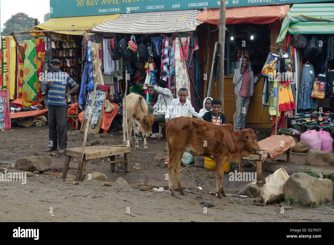 ETHIOPIA Street scenes on a rainy day in Chagni, Beni Shangul Gumuz region. A small shop with cow in foreground. Stock Photo