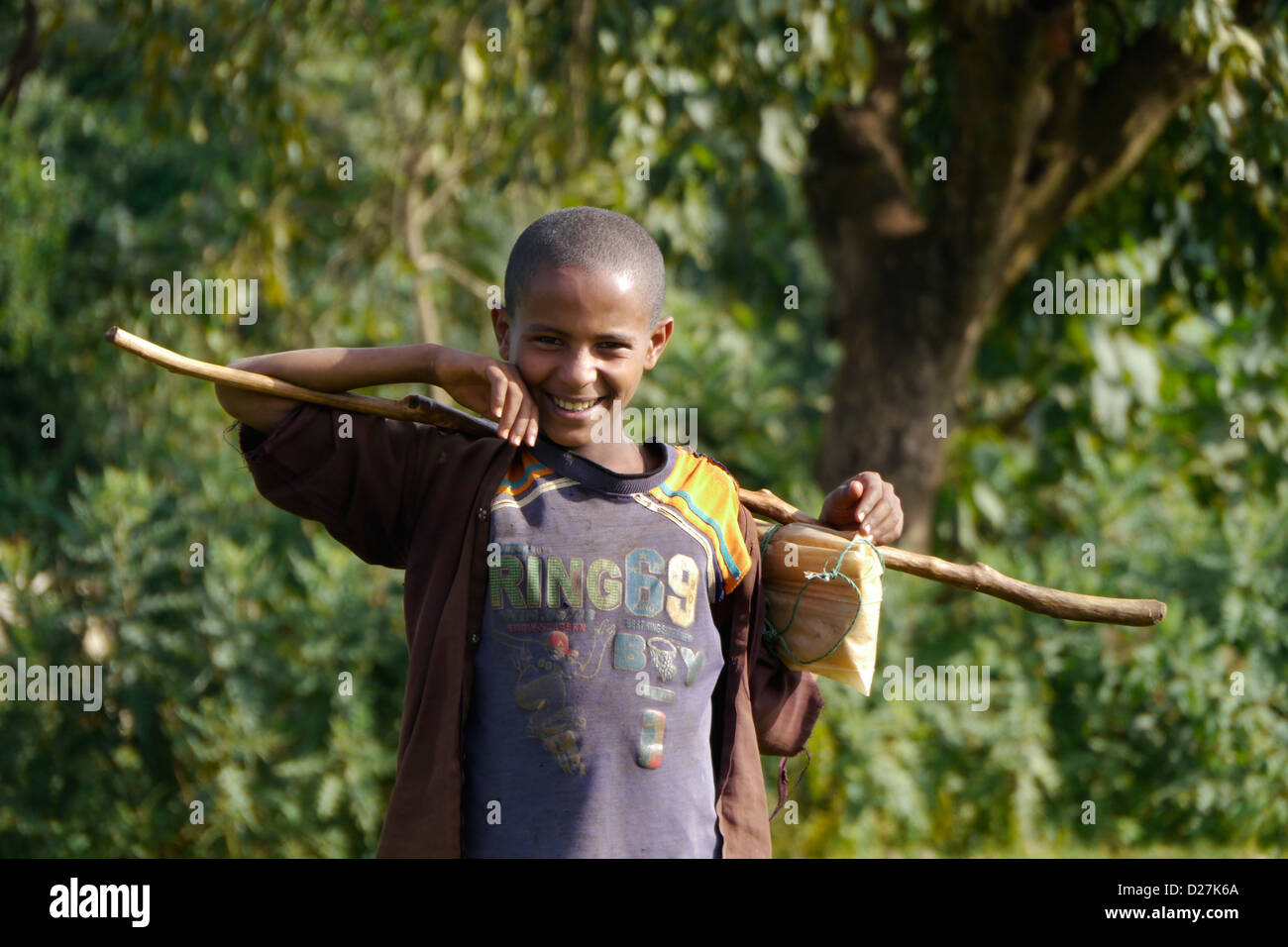 ETHIOPIA On the road between Chagni and Debate, Beni Shangul Gumuz region. Boy with stick. Stock Photo