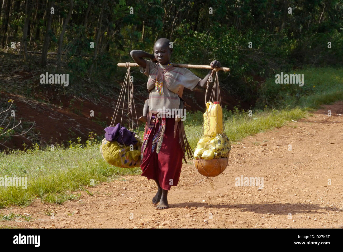 ETHIOPIA On the road between Chagni and Debate, Beni Shangul Gumuz region. Gumuz woman carrying goods to or from market. Stock Photo