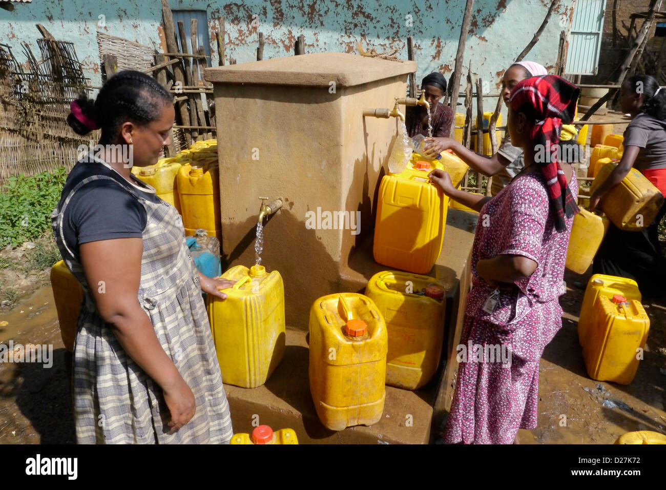 ETHIOPIA Women collecting water from a communal water point in Debate. Beni Shangul Gumuz region. Stock Photo