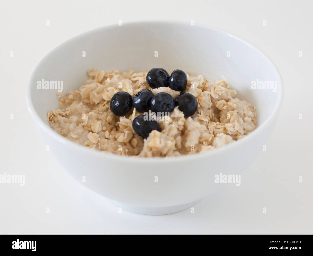 Oatmeal with blueberries on white background Stock Photo