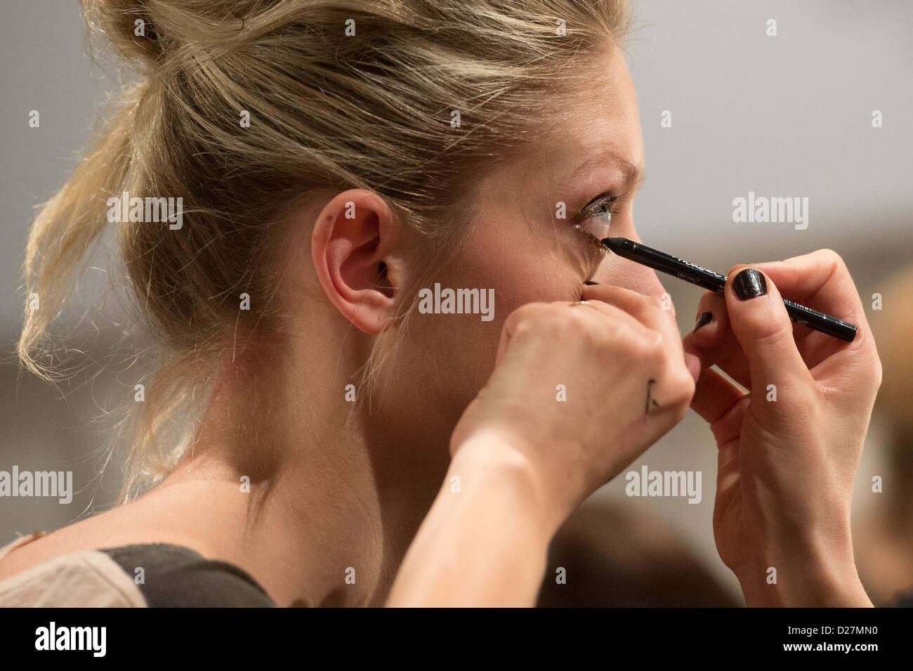 A model gets her lips done before the Anja Gockel show during the Mercedes-Benz Fashion Week in Berlin, Germany,15 January 2013. The presentations of the autumn/winter 2013/2014 collections take place from 15 to 18 January 2013. Photo: Maurizio Gambarini/dpa Stock Photo