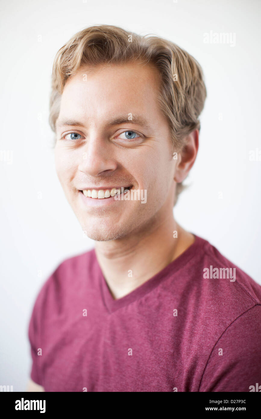 Studio Shot of young adult man expressing happiness Stock Photo
