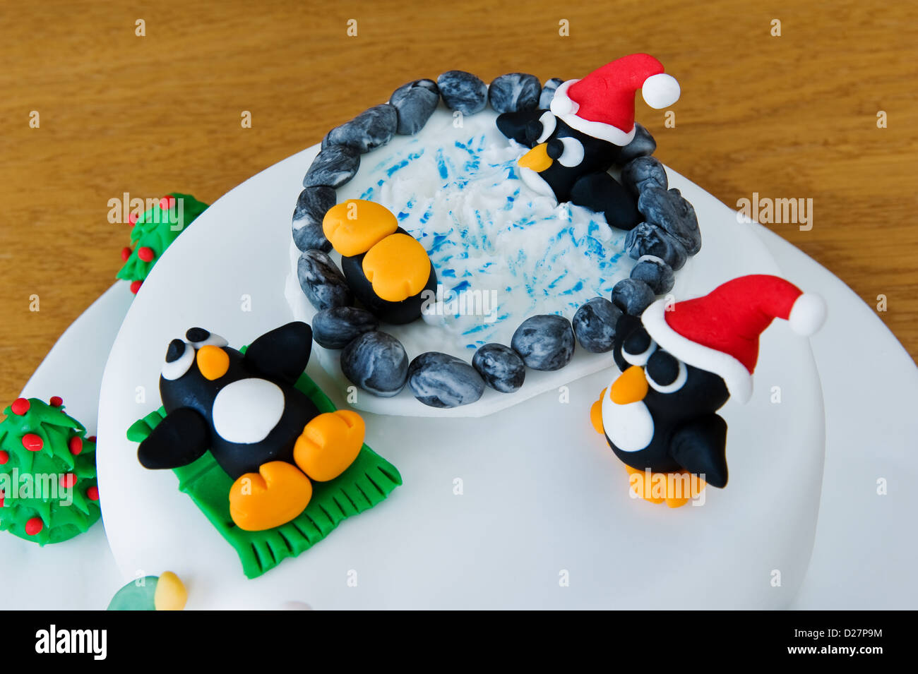 Novelty christmas cake, decorated with amusing penguins and snowmen. Stock Photo