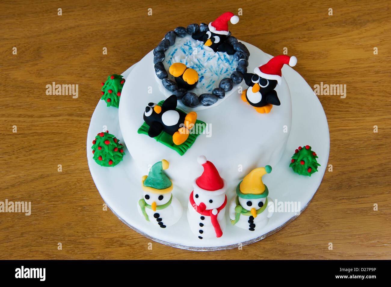 Novelty christmas cake, decorated with amusing penguins and snowmen. Stock Photo