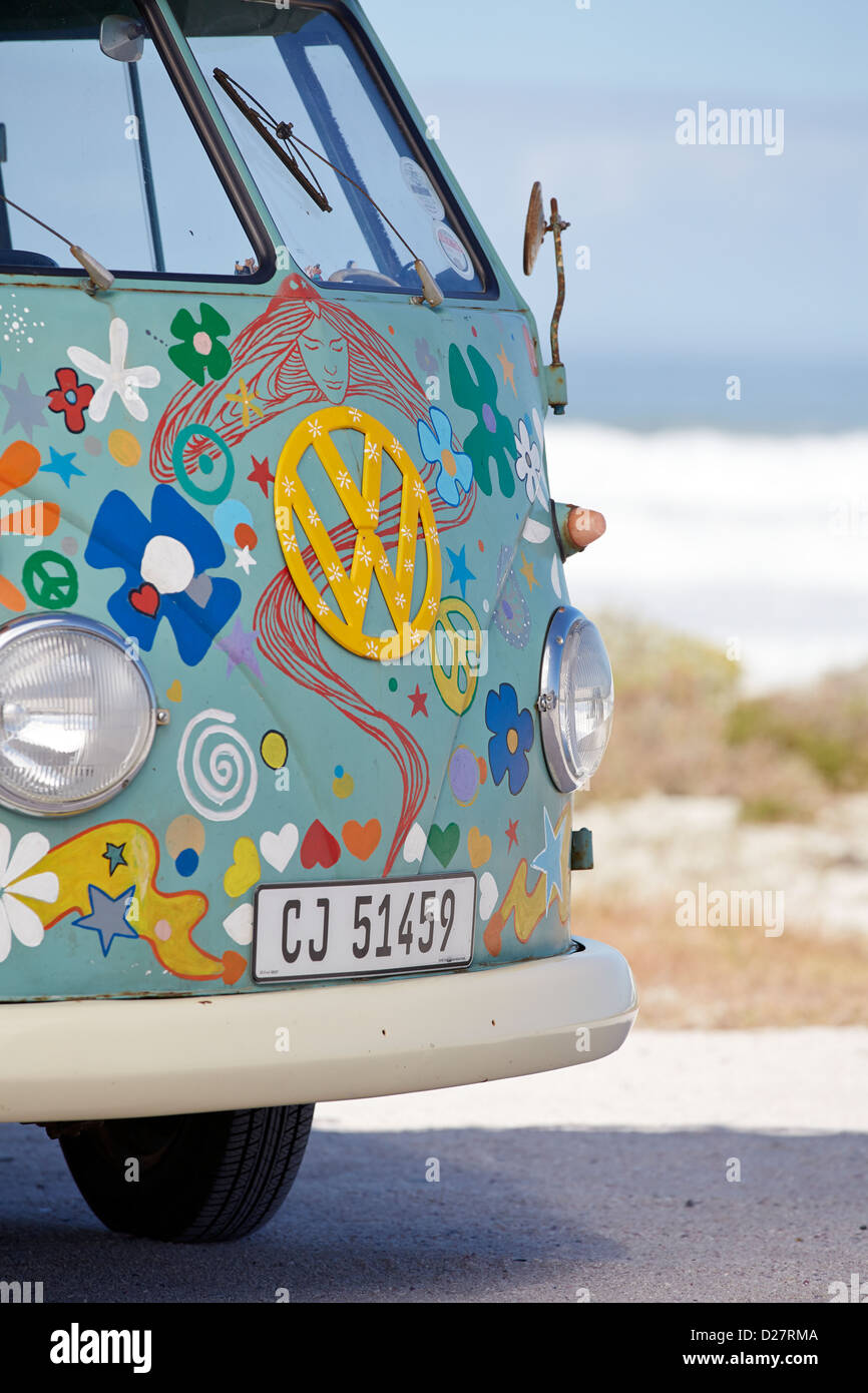 Front end of a flower power customized VW camper van at the seaside Stock Photo