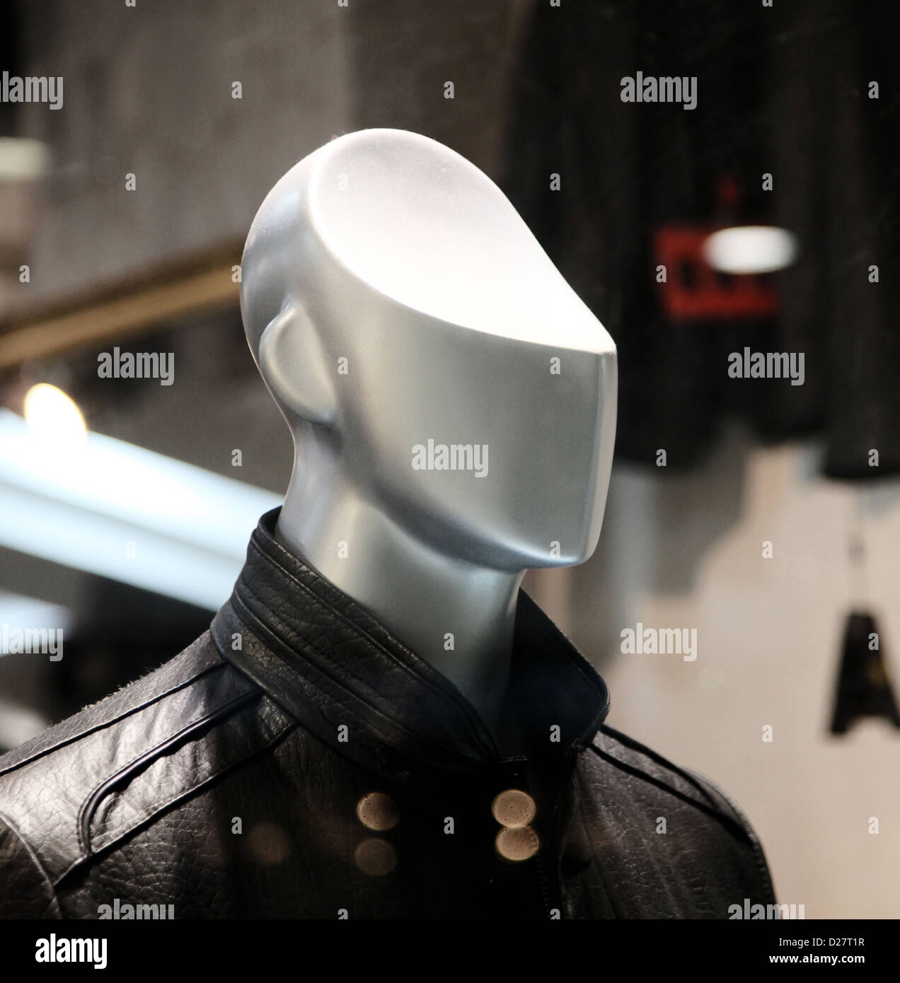 It's a photo of a close up of a male plastic model  in a fashion shop window. The head is cut like no brain. Stock Photo