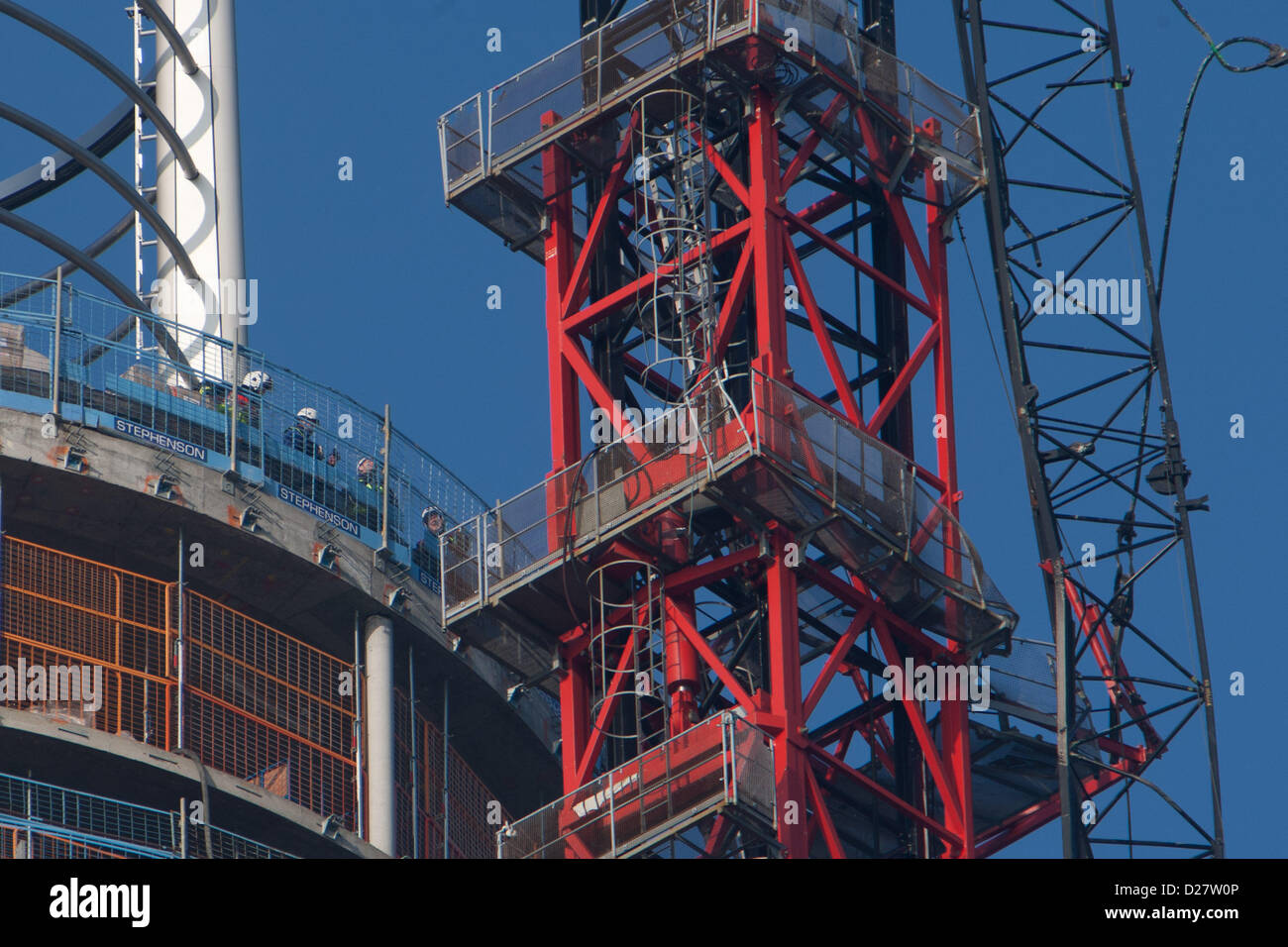 London, UK. 16th January 2013. Firefighters inspecting damaged crane on St George's Wharf tower that an Agusta 109 helicopter had collided with in Wandsworth Road in Vauxhall, London, 16th January 2013. Credit:  martyn wheatley / Alamy Live News Stock Photo