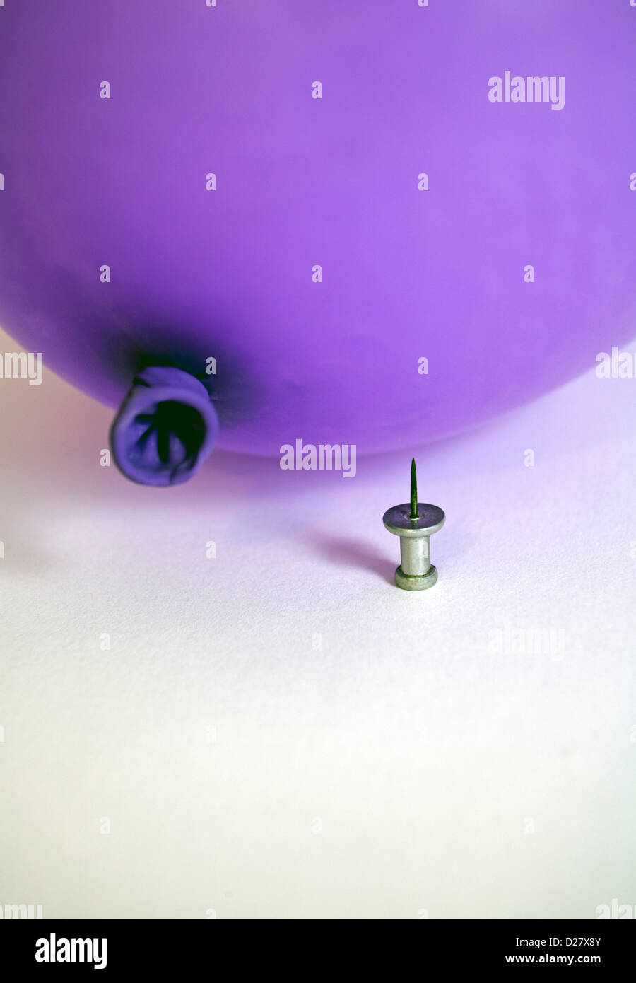Pushpin Underneath Purple Balloon Stock Photo