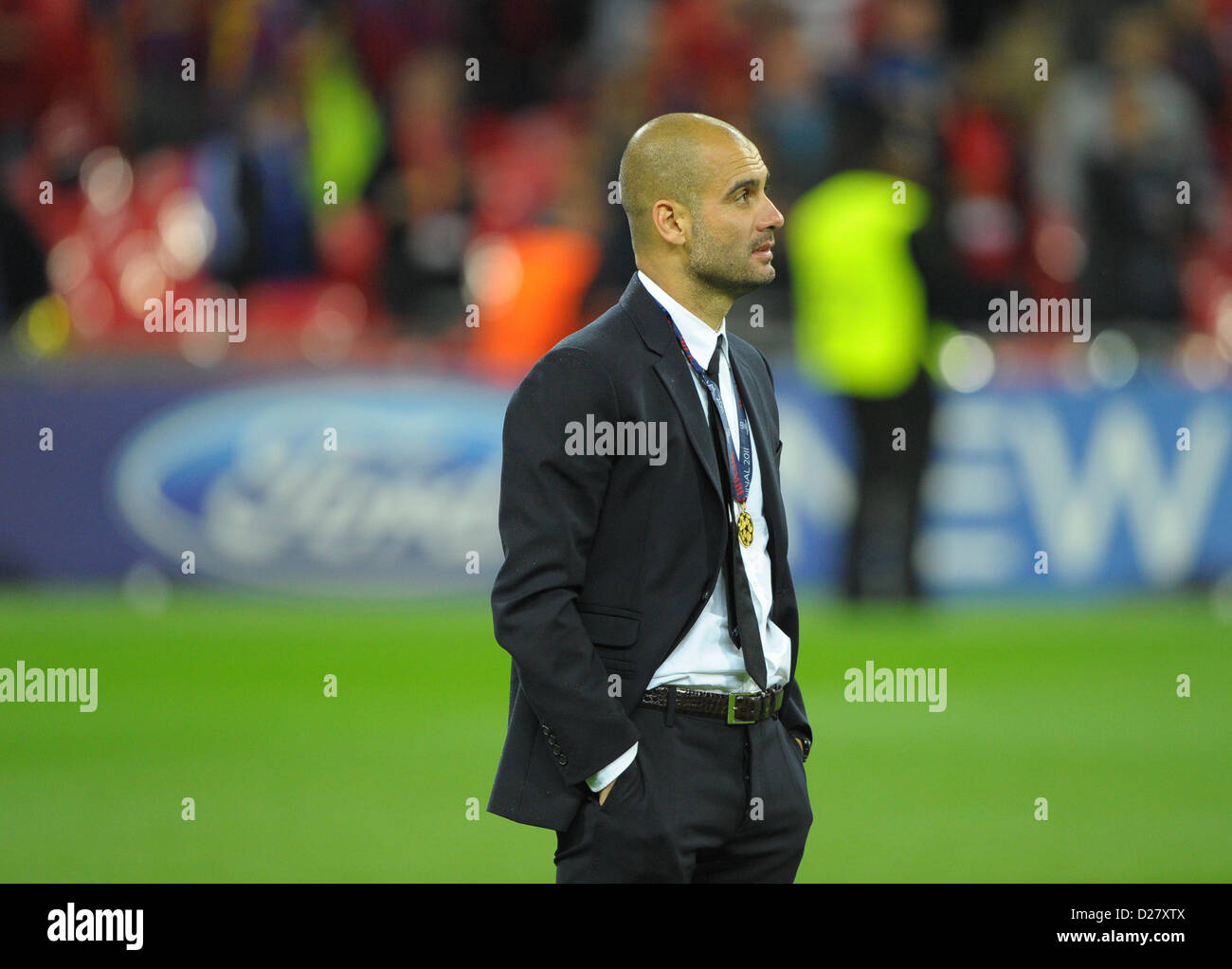 Barcelona's coach Josep Guardiola stands on the pitch after the UEFA Stock  Photo - Alamy