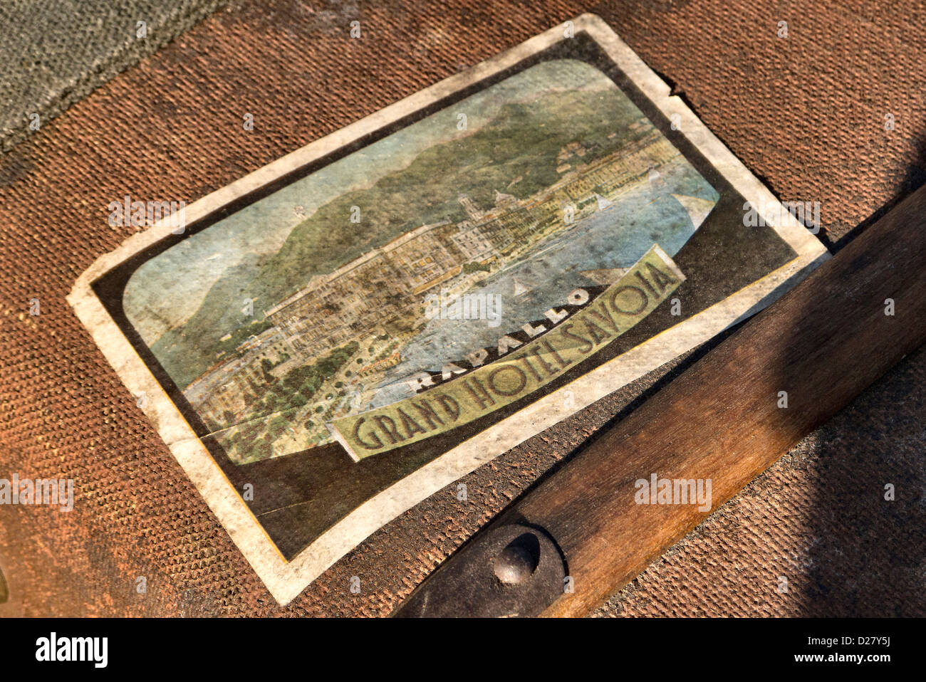 1930's hotel label for the Grand Hotel Savoia stuck to a on a vintage suitcase. Stock Photo