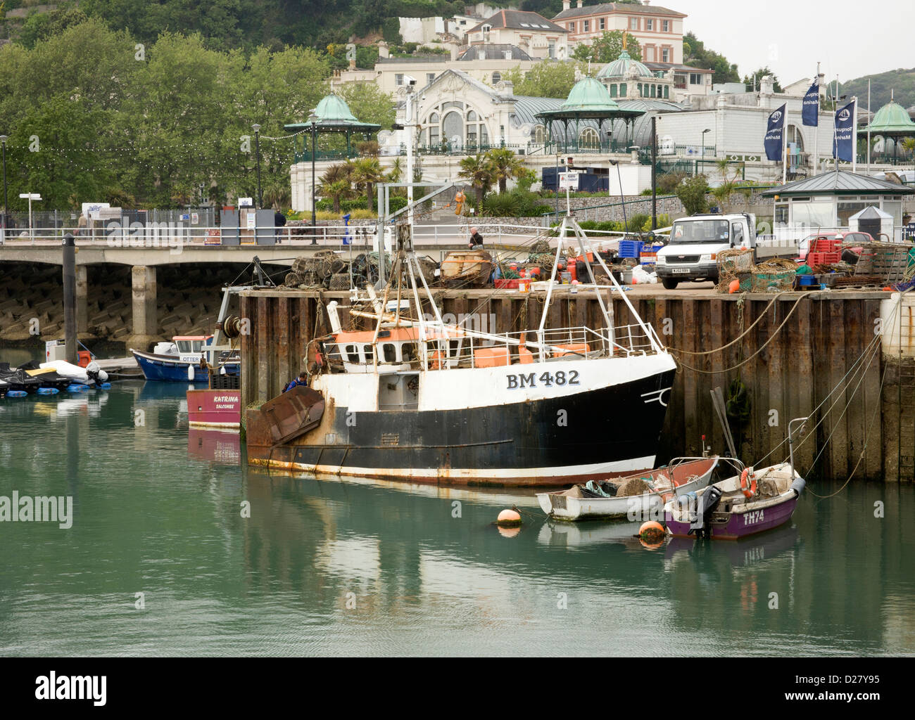 Torquay harbour.Torquay harbour quayside with fishing boat moored Stock