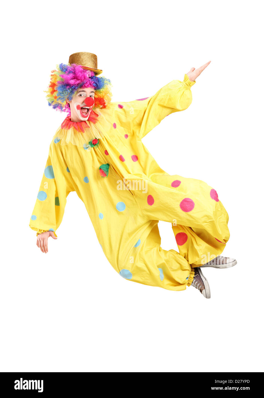 Full length portrait of a male clown jumping isolated on white
