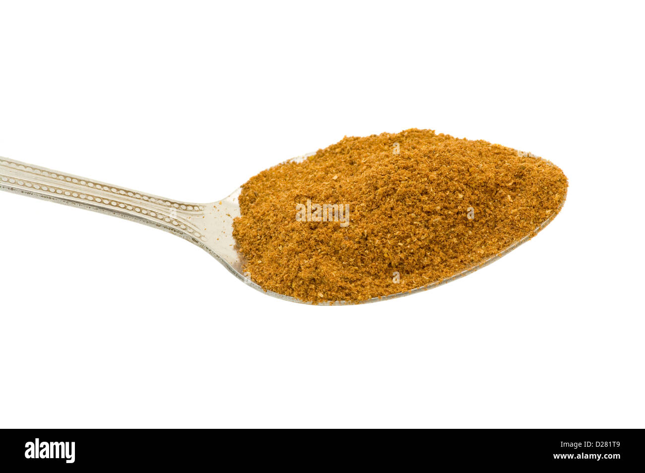 A Teaspoon Of Mixed Ground Spice Against a White Background Stock Photo