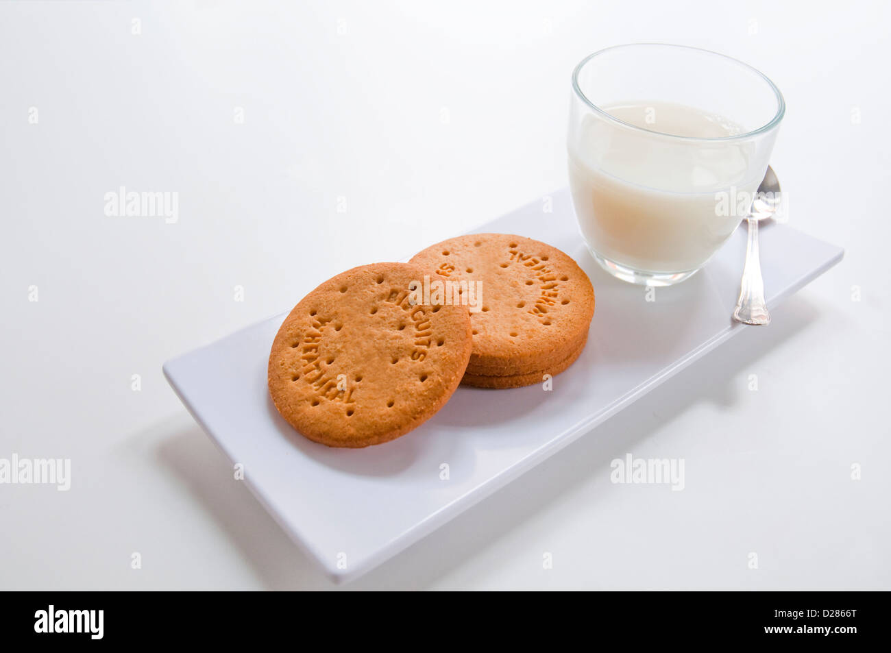 Wholemeal biscuits and glass of milk. Stock Photo