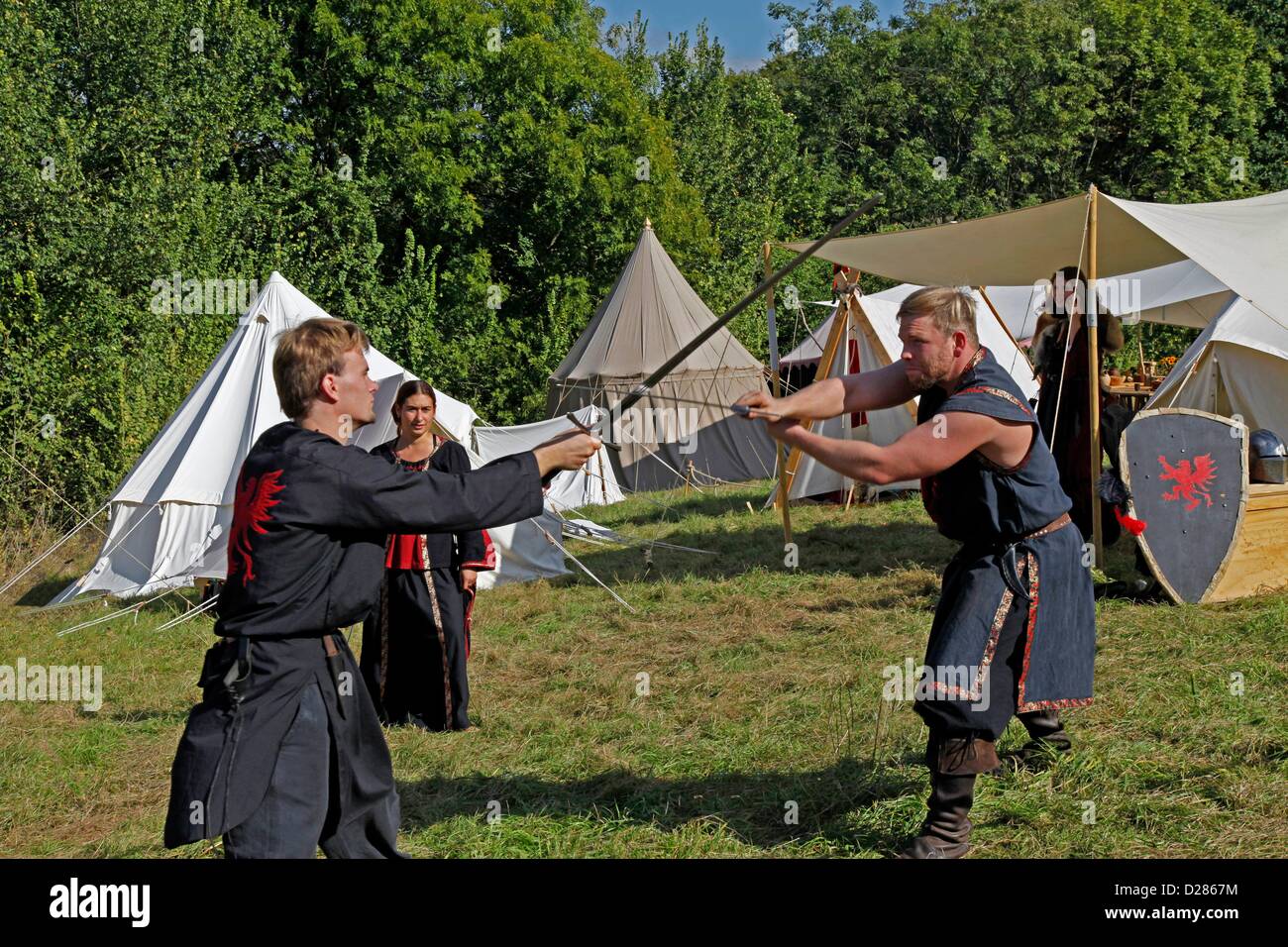 medieval sword fighting, medieval camp on the meadows in front of