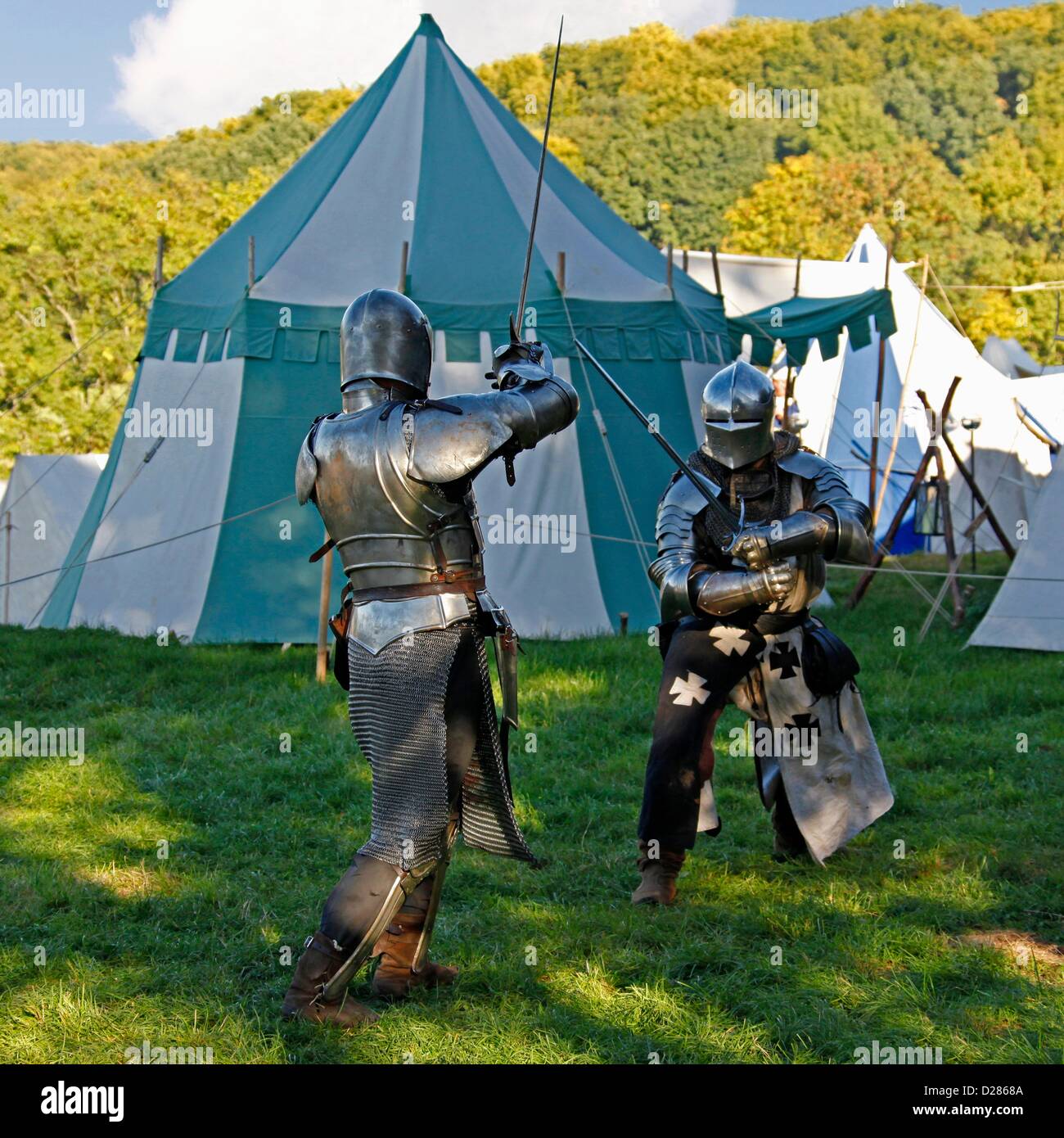 knightly sword fighting, medieval camp on the meadows in front of the