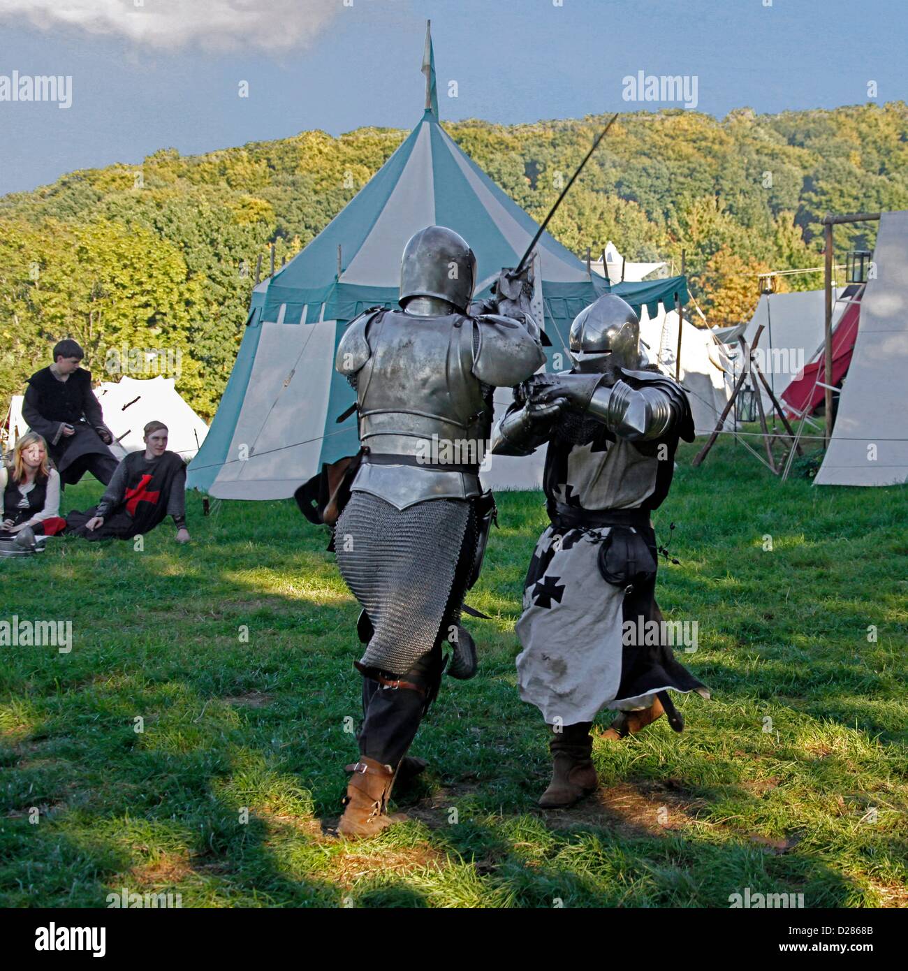 knightly sword fighting, medieval camp on the meadows in front of the
